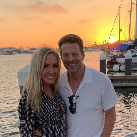 Shannon Beador and John Janssen pose for a picture at a beautiful setting.